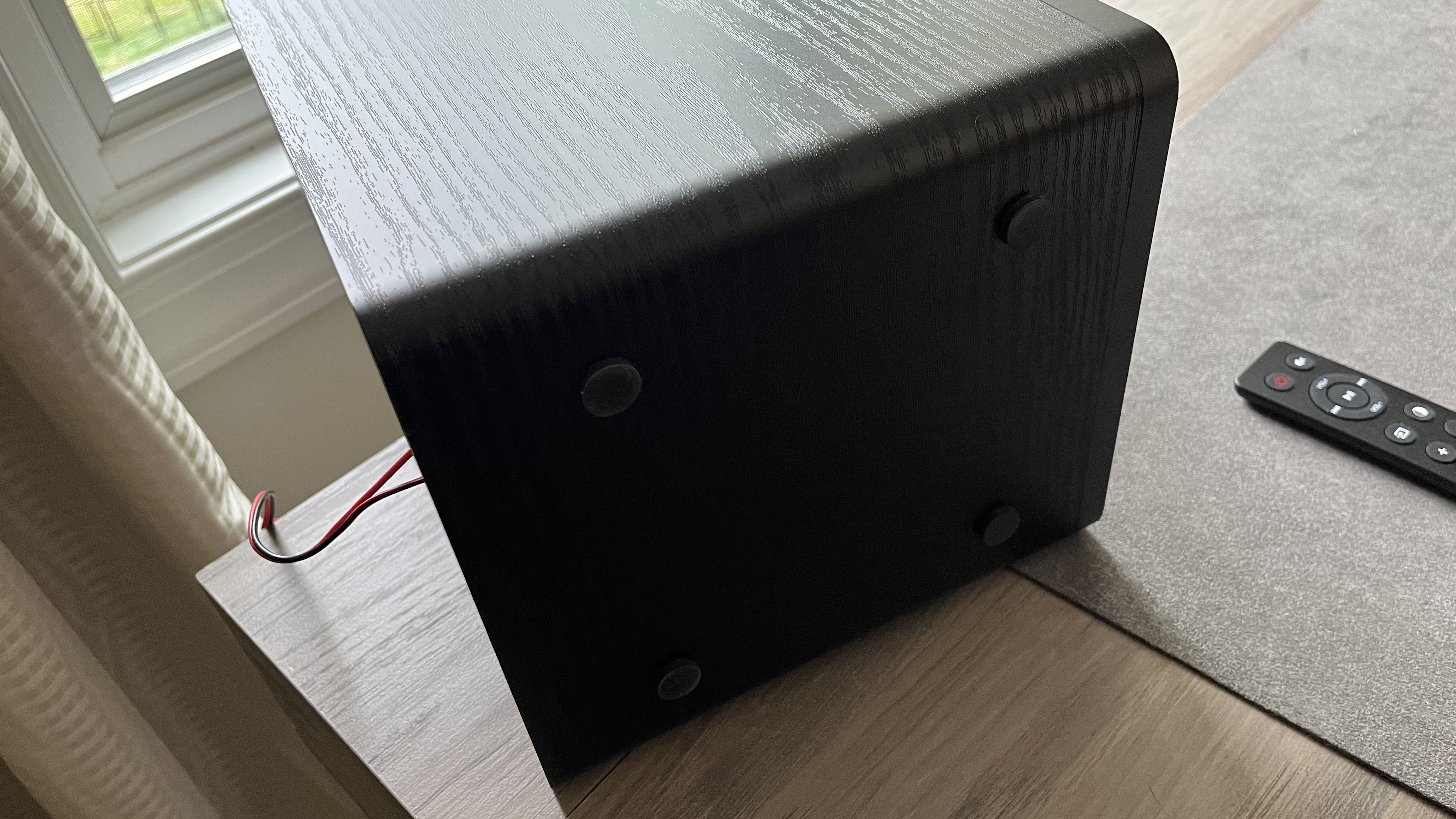 Fluance Ai61 stereo speakers, tipped on their side, to show rubber feet on the bottom panel