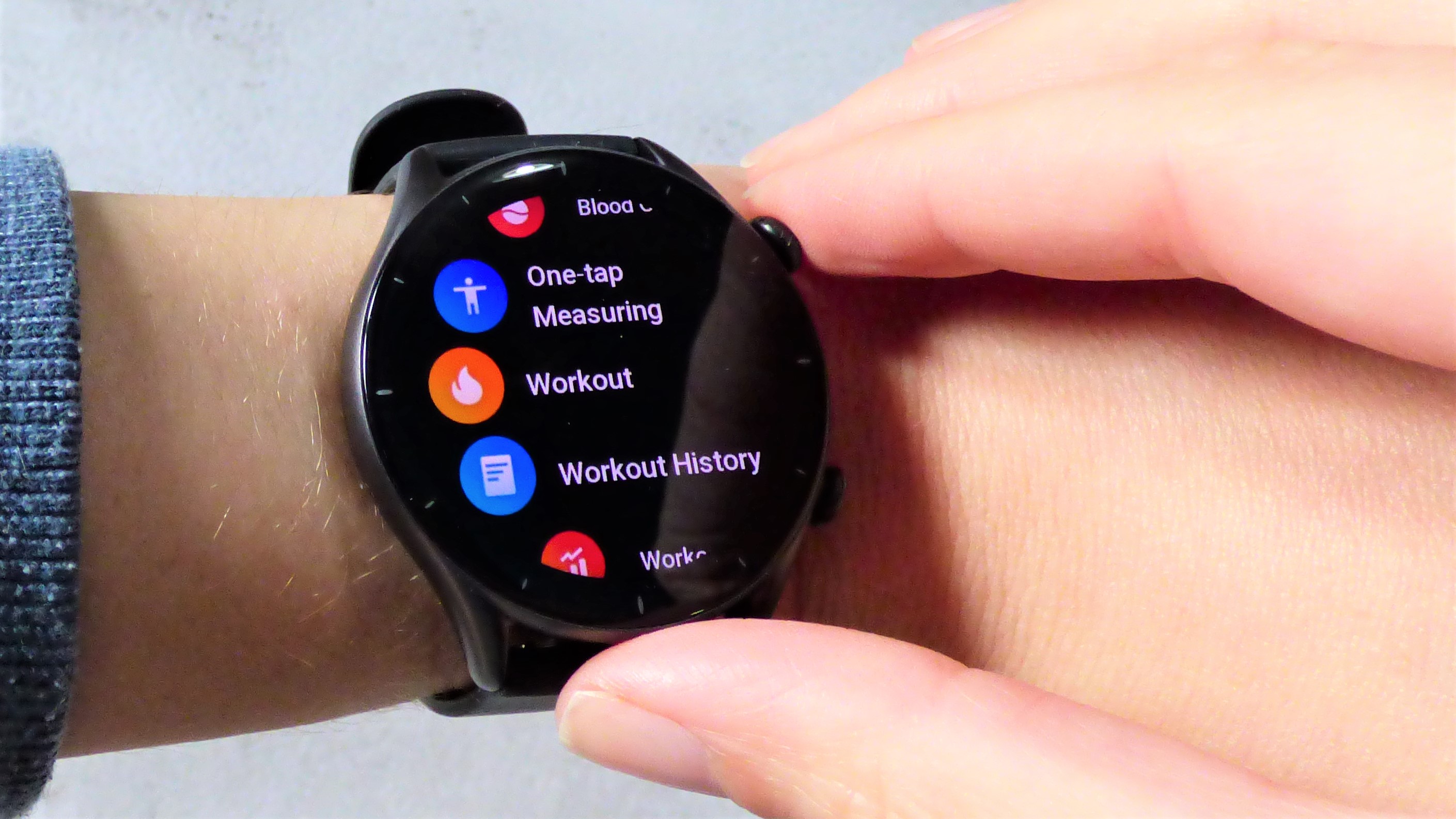 Woman scrolling through menu on Amazfit GTR 3 watch