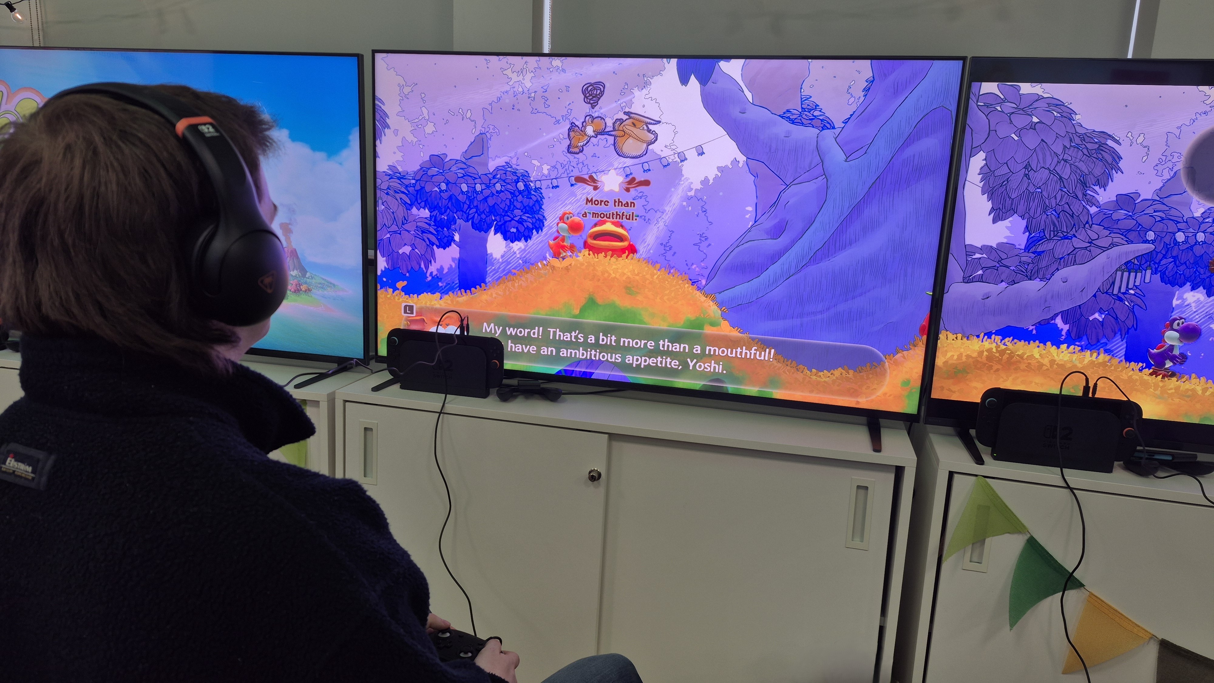 Over the shoulder image of man playing Yoshi and the Mysterious Book
