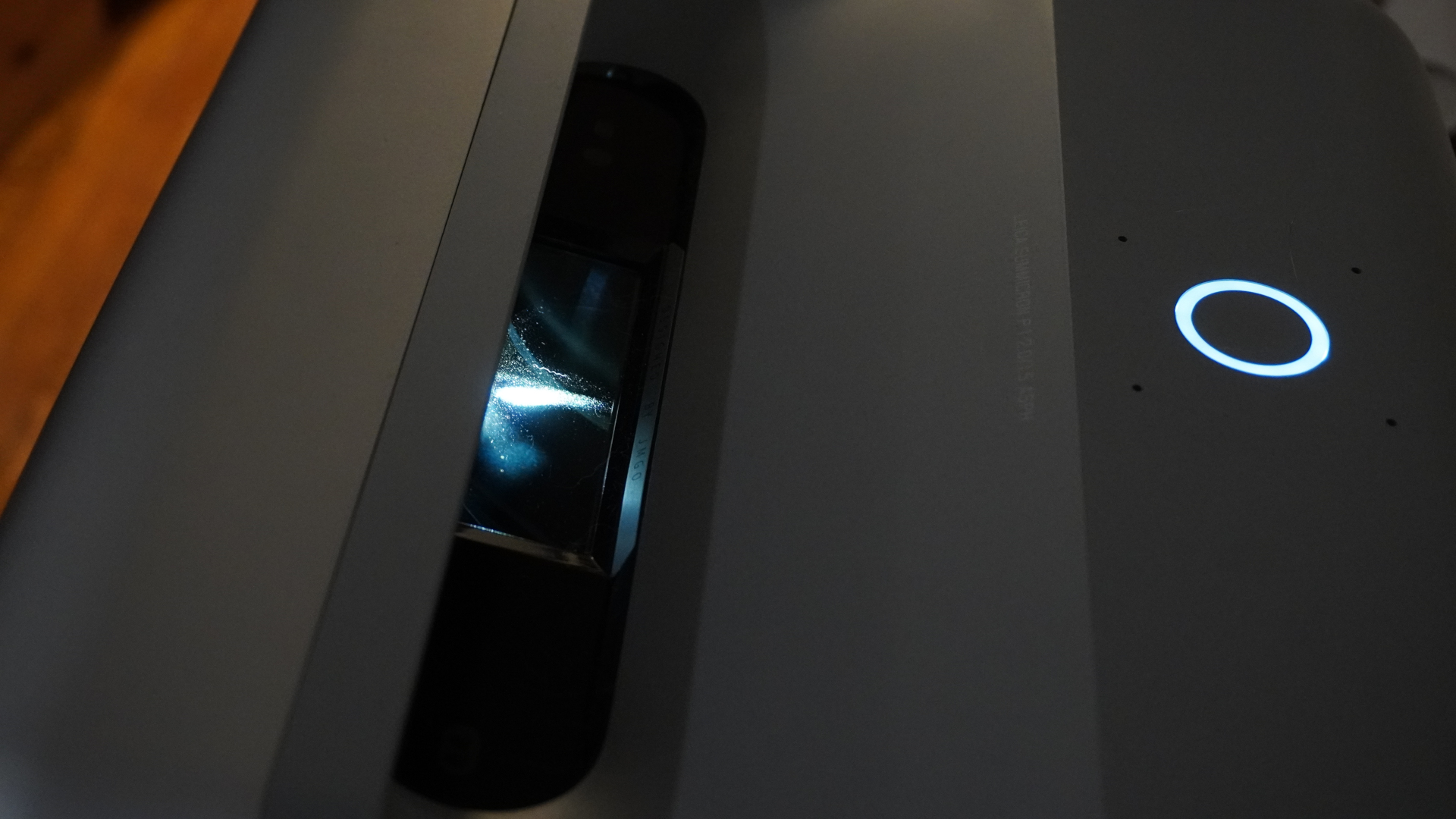The JMGO O1 Pro Ultra Short Throw projector setup in a living room.