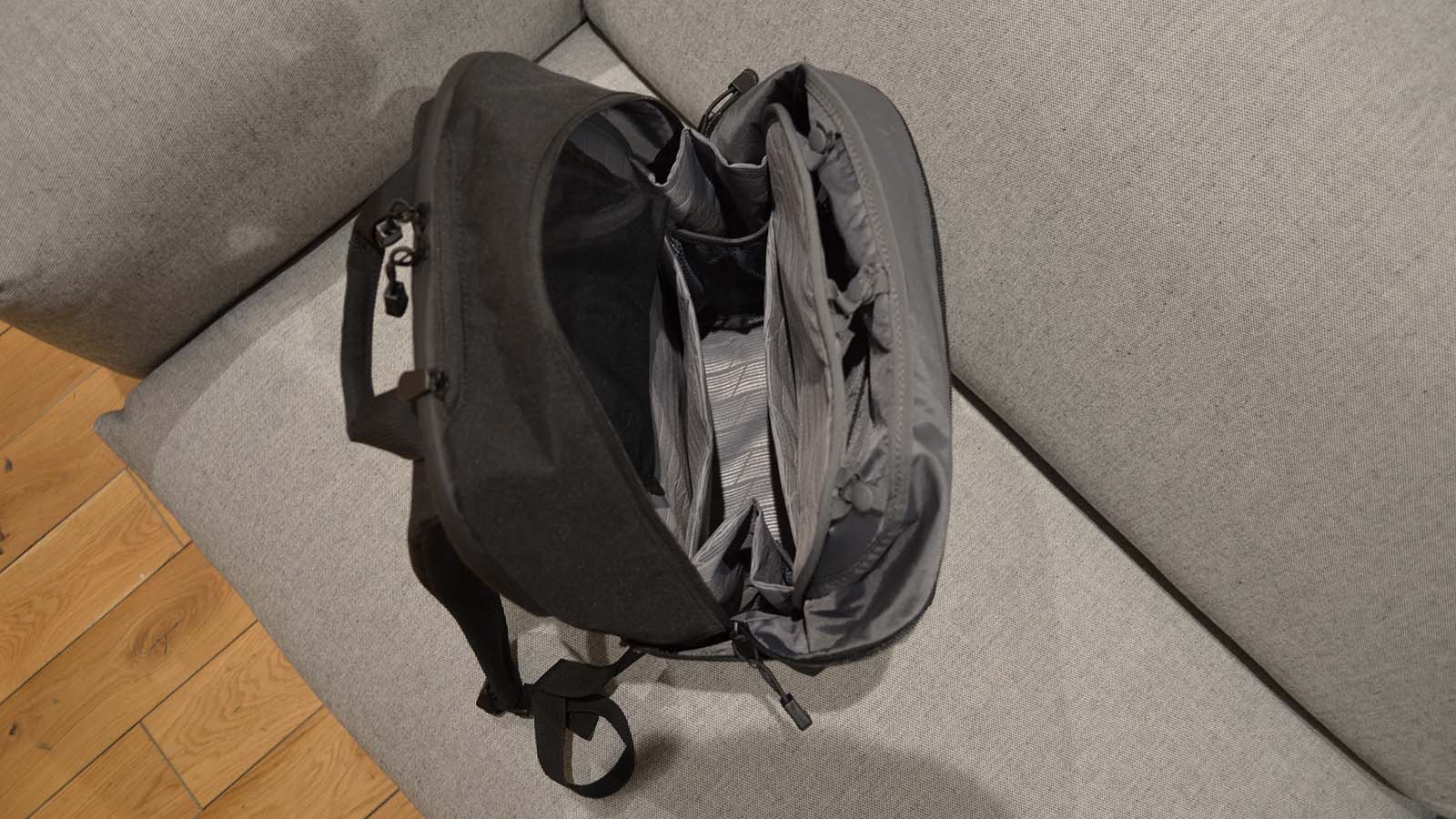 A Lo &amp;amp; Sons Hanover Deluxe 2 backpack open on a gray couch