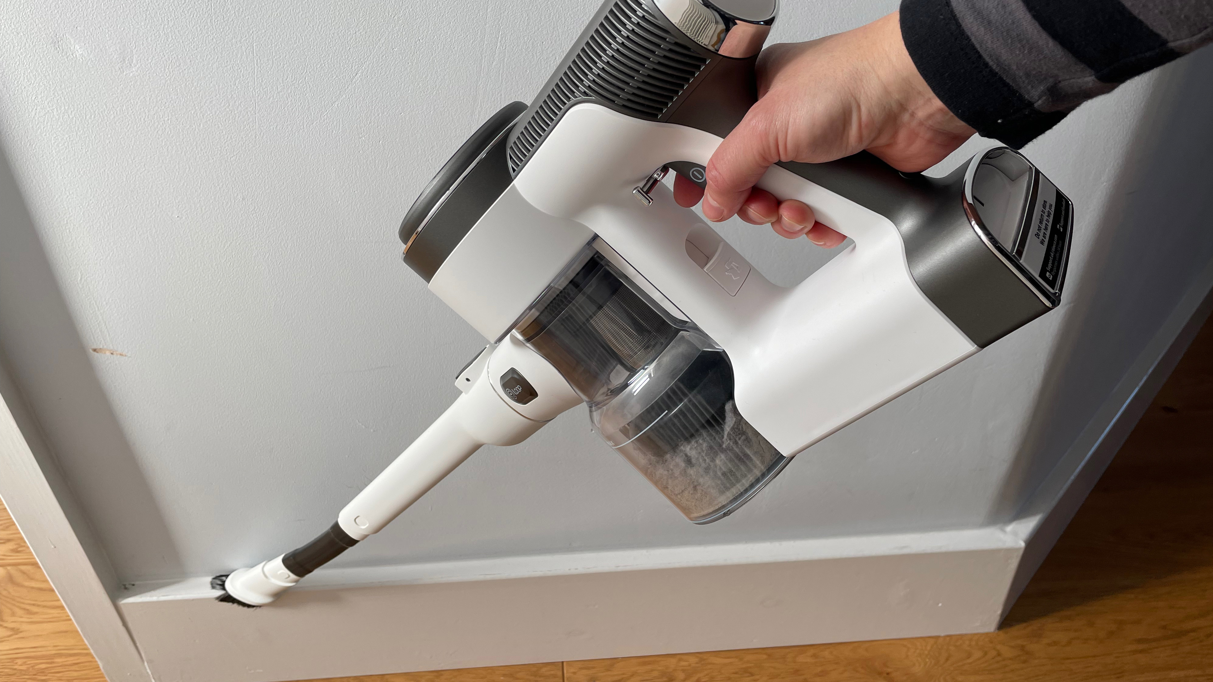 The Tineco Pure One S12 Pro EX being use din handheld mode to clean base boards