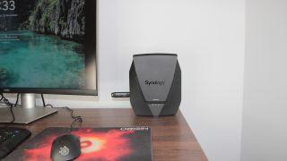 Various images of the Synology WRX560 router hardware.