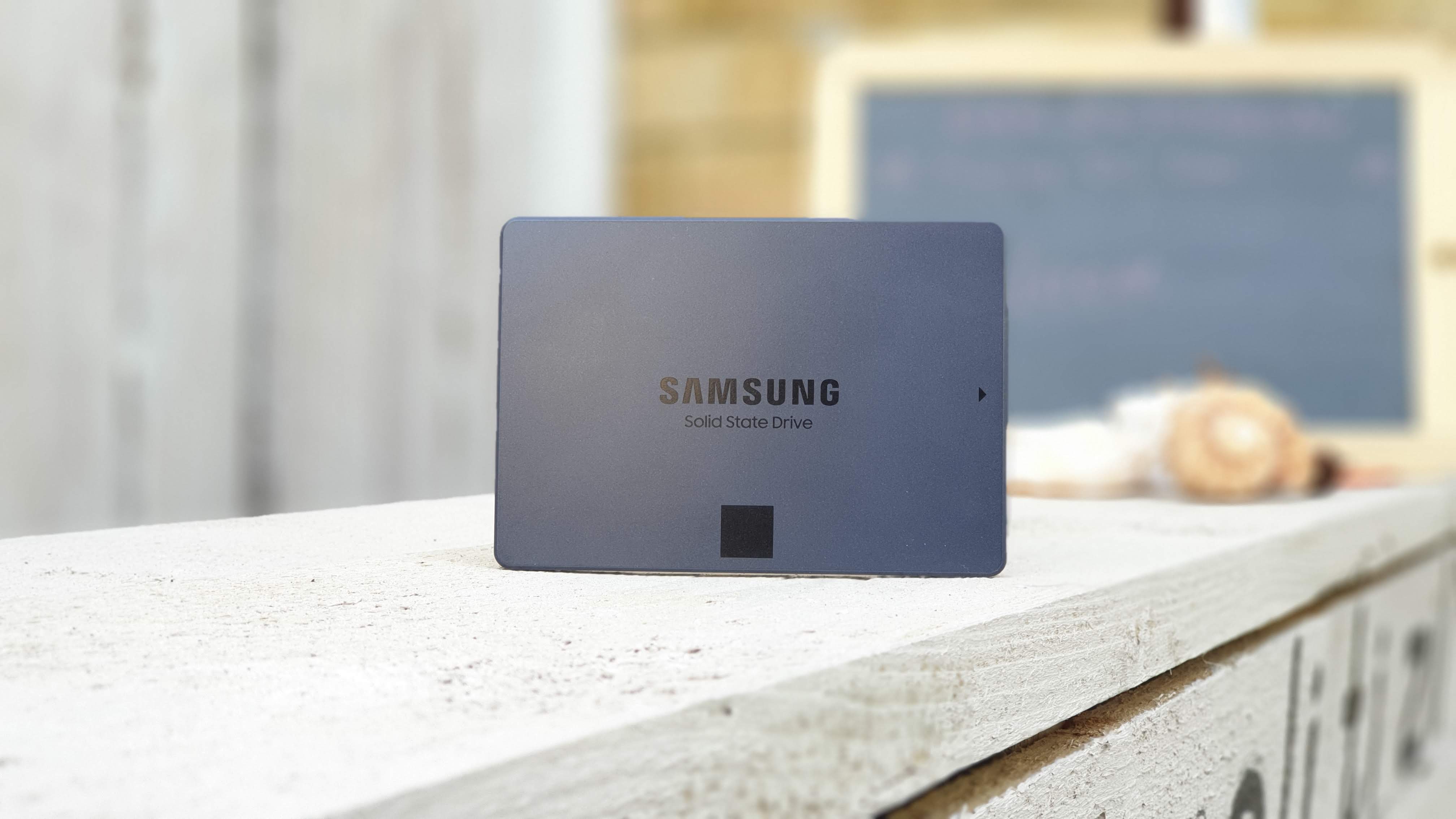 Samsung 870 QVO SSD on a wooden shelf