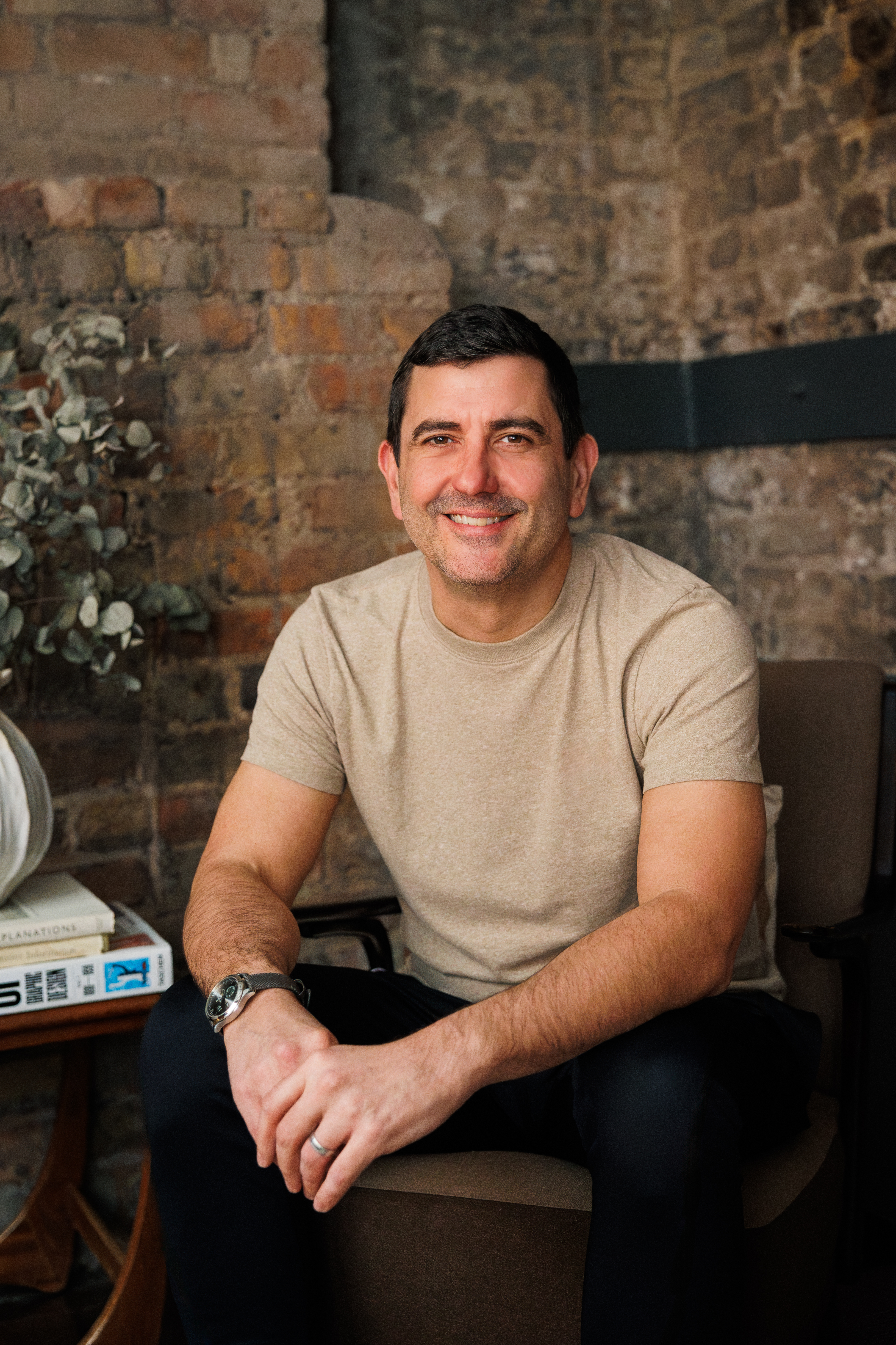 Affinity CEO Ash Hewson in an office with exposed brickwork