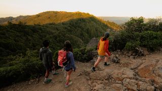 Strava users hike up a mountain during the golden hour on a clear day