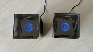 The glowing status LEDs on the top of the Asus ZenWiFi Pro XT12 mesh routers