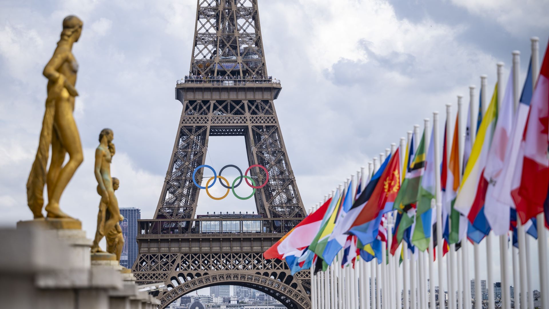 A general view of the Eiffel Tower with the Olympics rings pictured with national flags of competing countries from the Place du Trocadero ahead of Paris 2024 Olympic Games on July 21, 2024 in Paris, France.