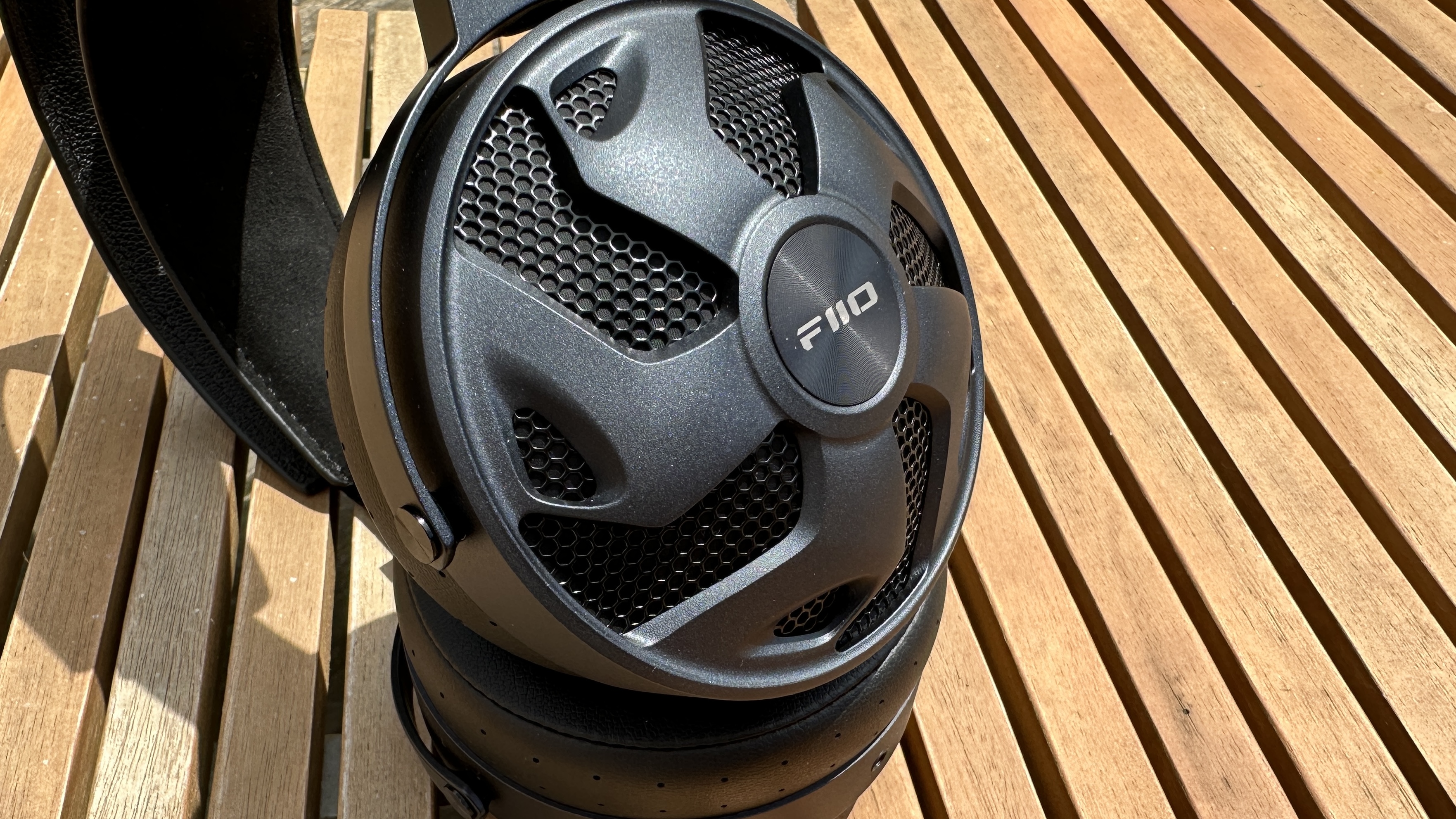 A close-up of the FiiO FT3 headhpones on a wooden surface