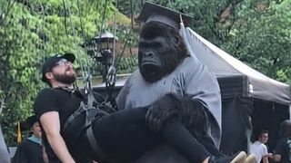 A behind-the-scenes image of a man wearing a gorilla costume while shooting DCU TV show The People v Gorilla Grodd