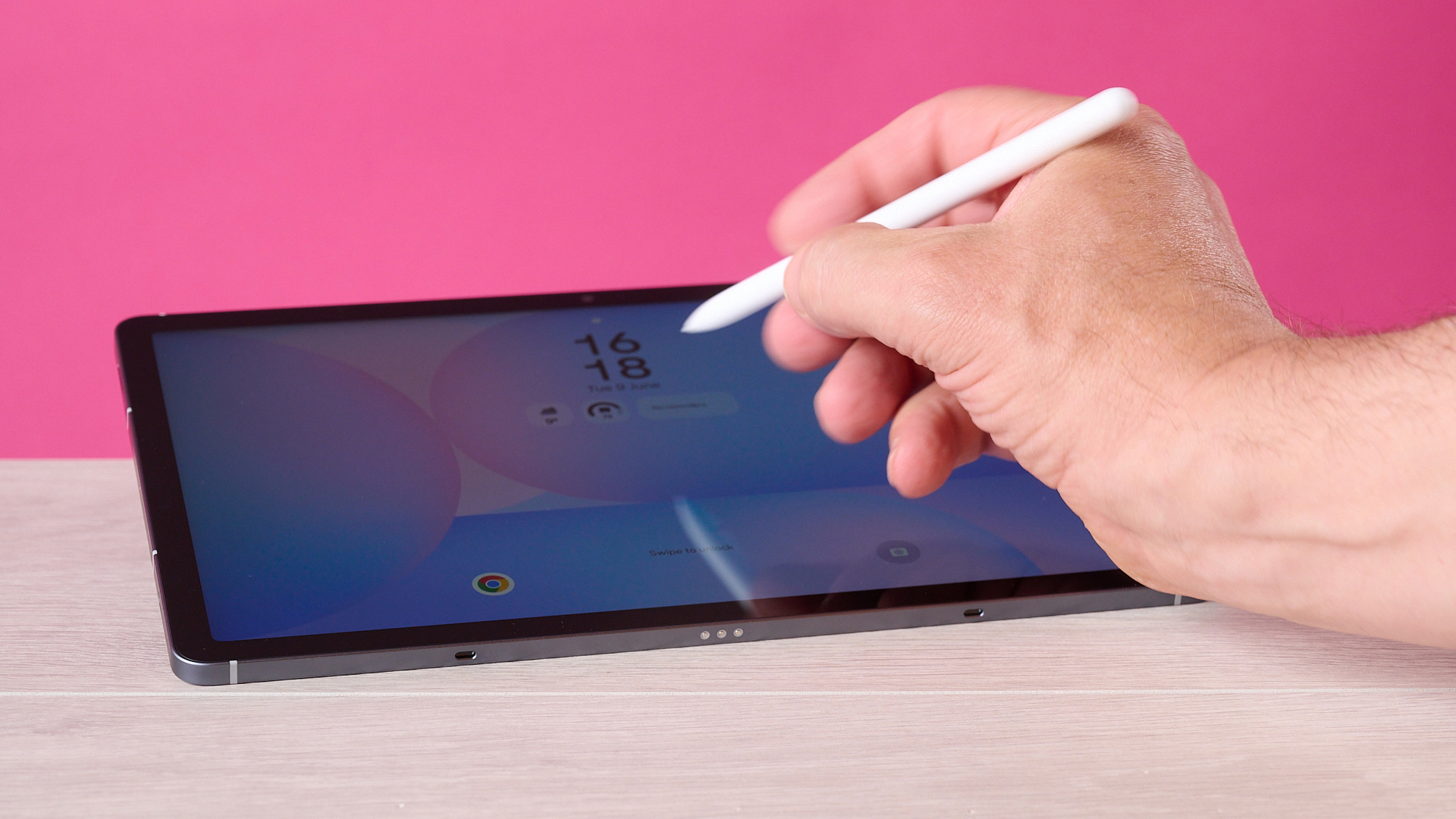 A man's hand using the S Pen to tap of the Samsung Galaxy Tab S10 FE's screen.