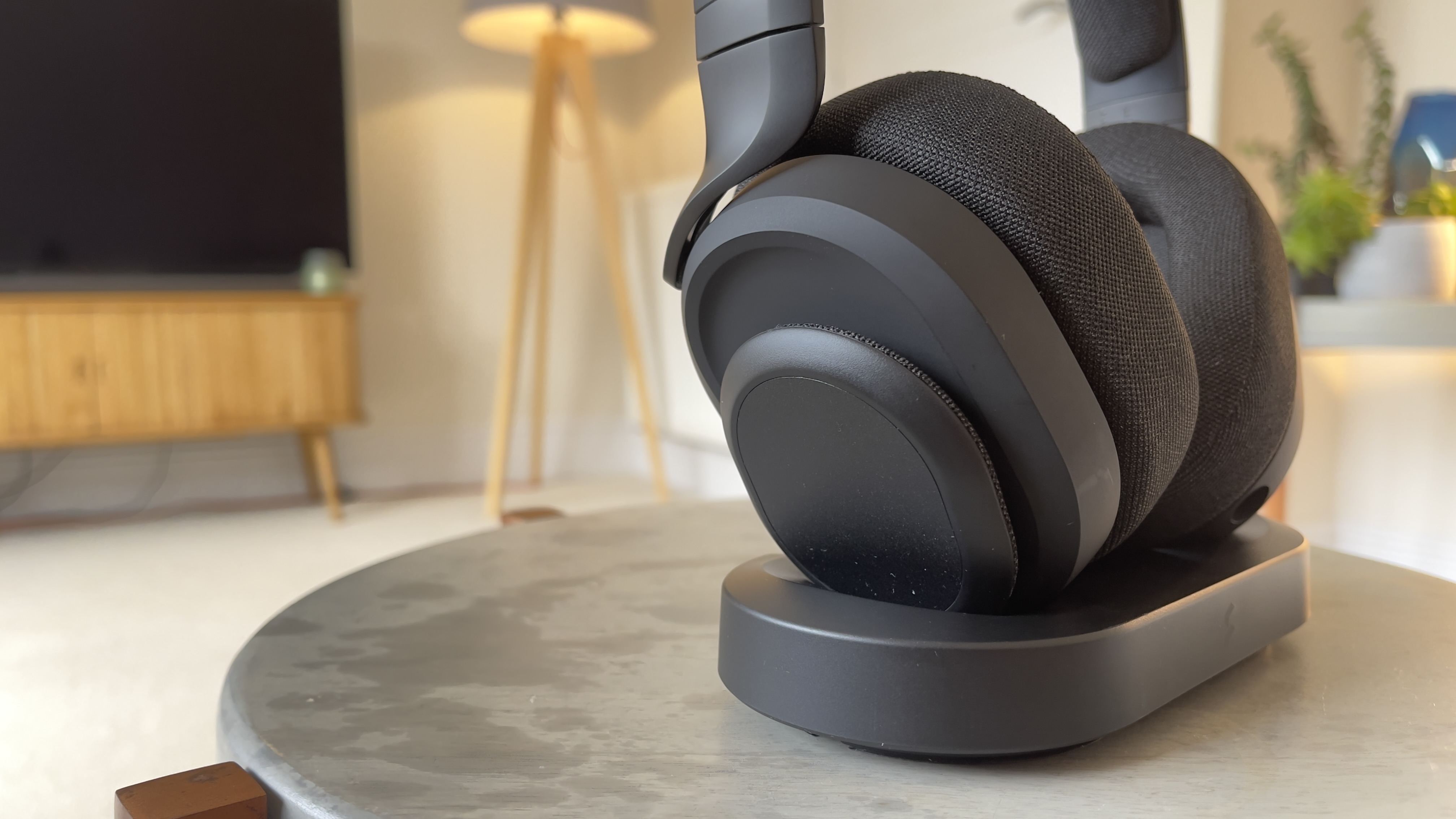 Fractal Scape wireless headset sat on a table in its charging dock.