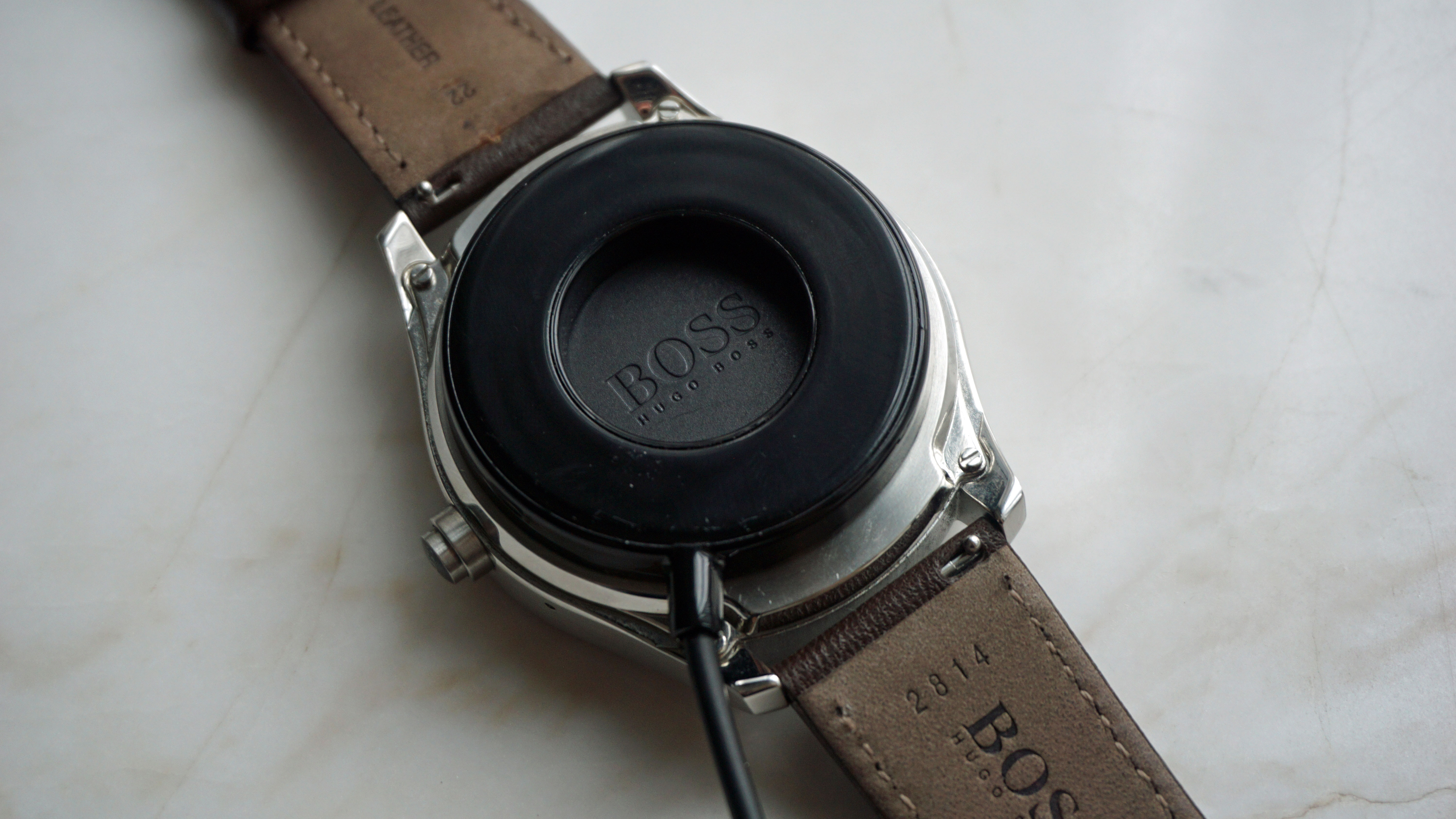 The Hugo Boss Touch attached to its charger