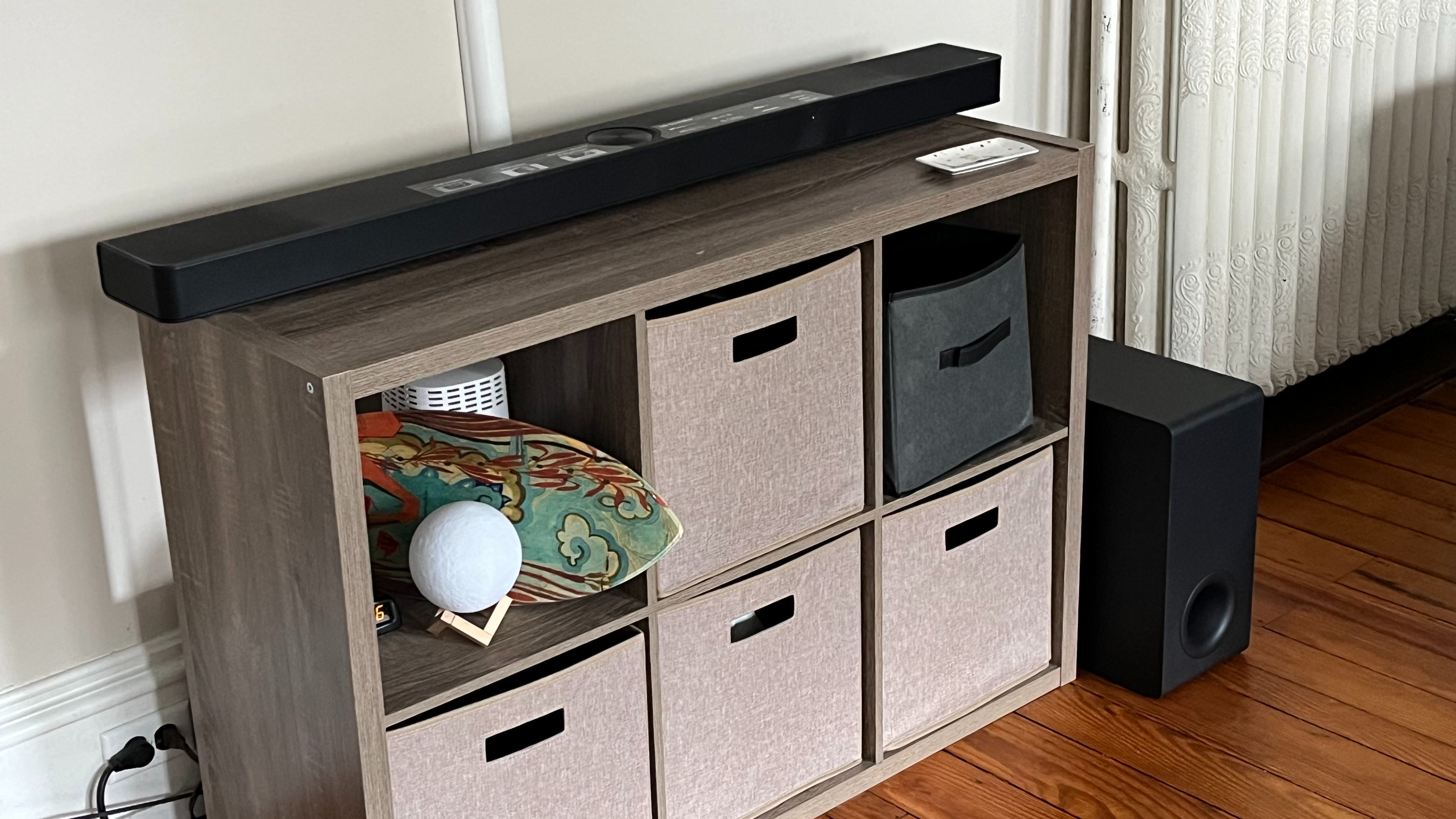 LG S95TR on table with subwoofer on floor