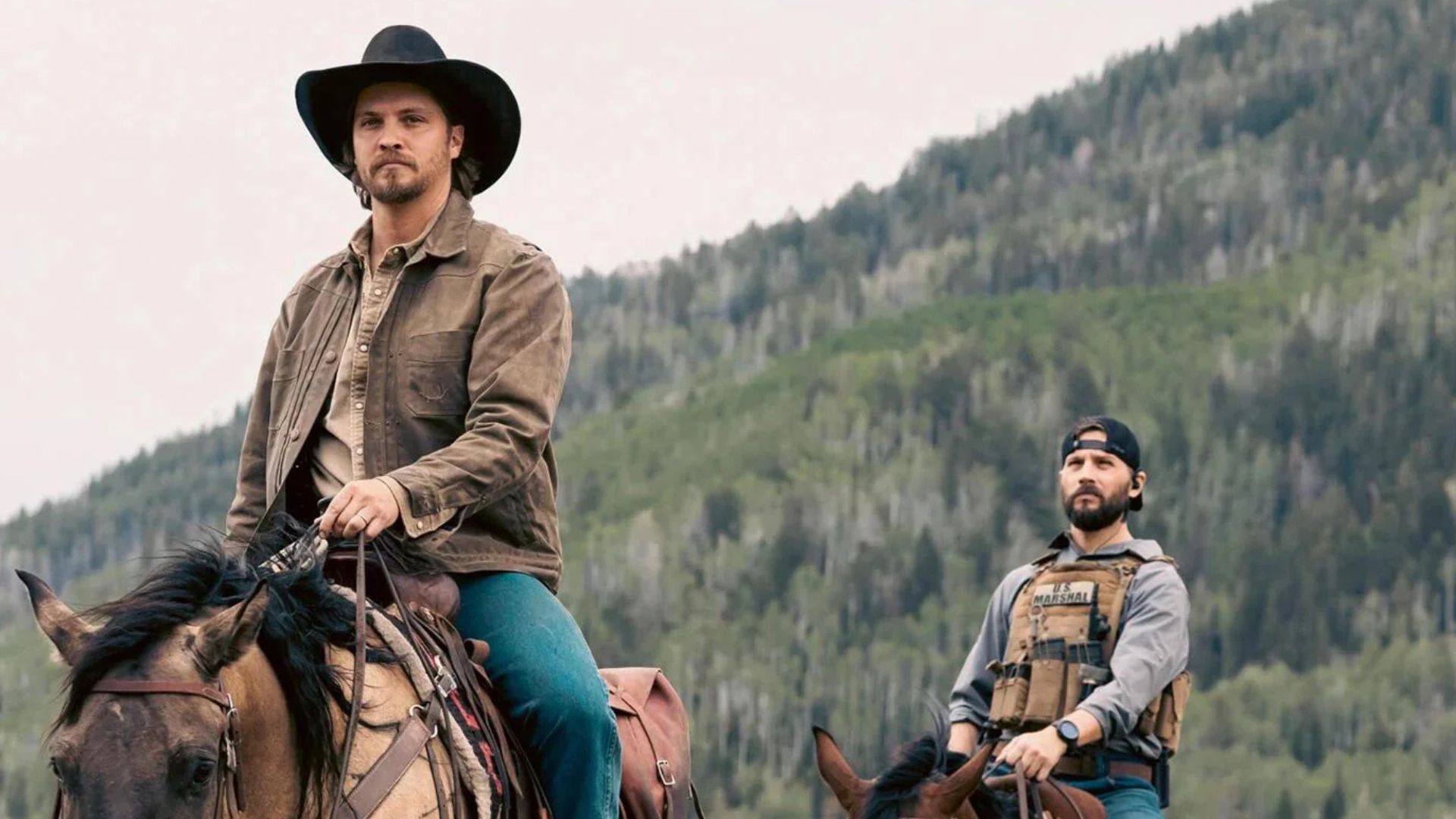 A marshal follows Kayce on horseback