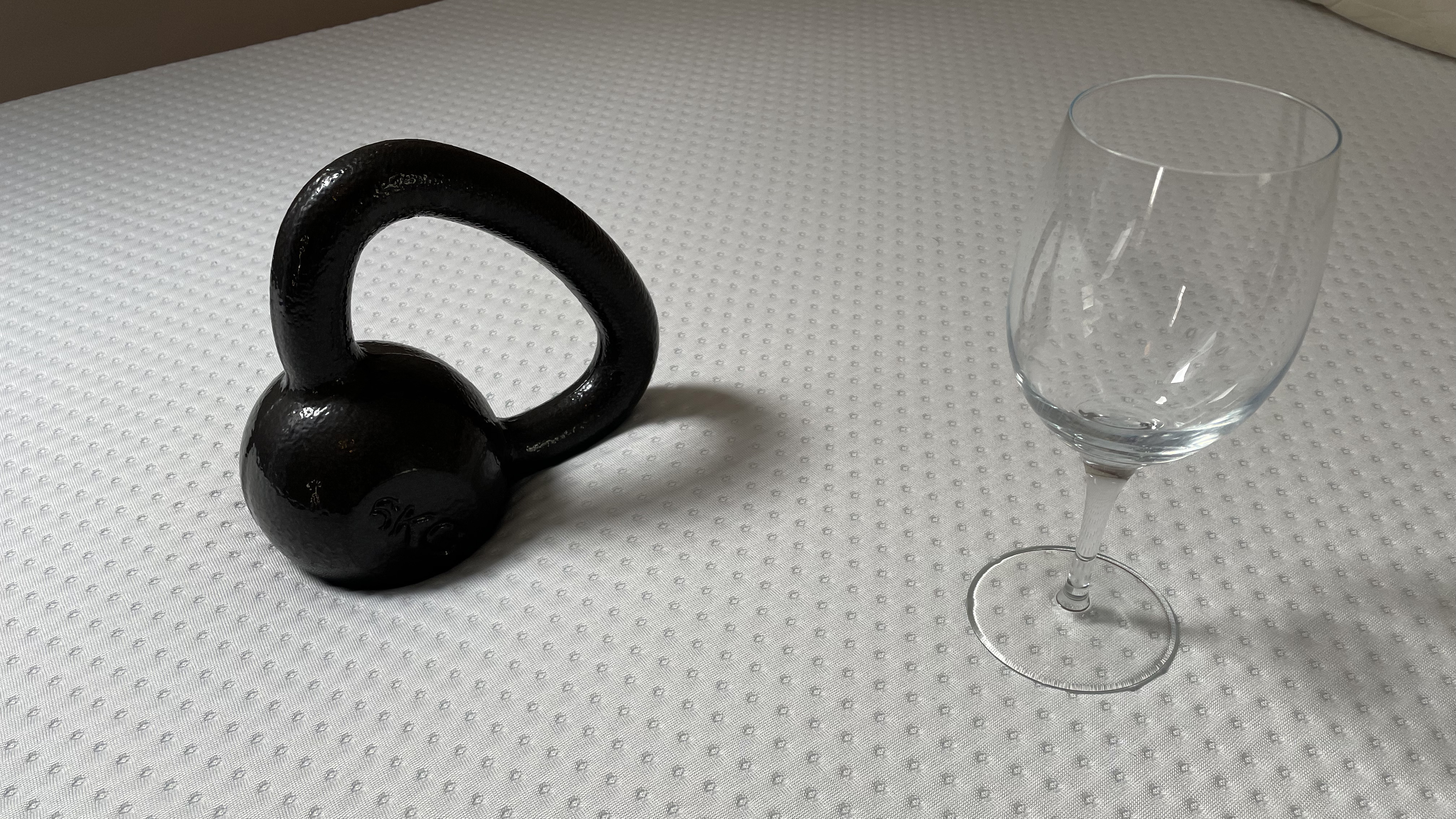 Emma Mattress with a weight and wine glass resting on it