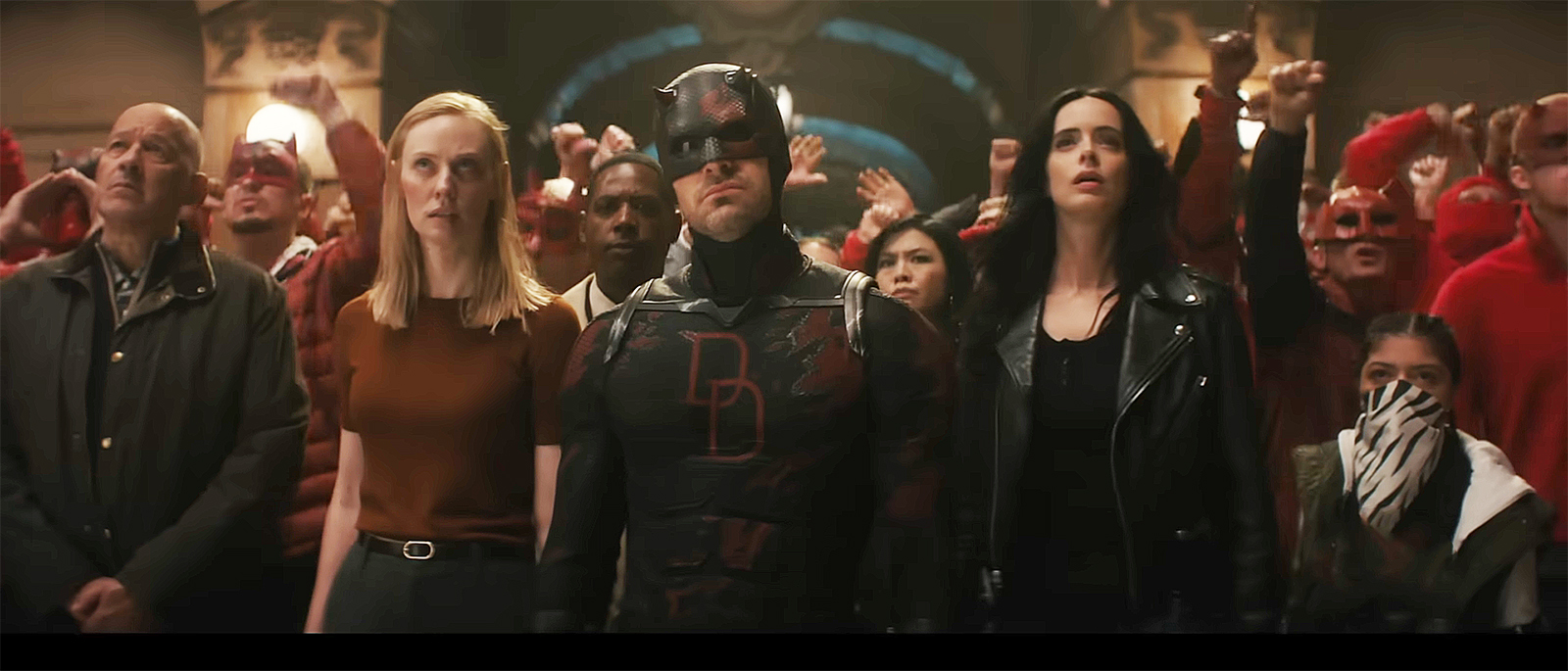 Karen Page, Daredevil, and Jessica Jones standing in front of a crowd in Daredevil: Born Again season 2