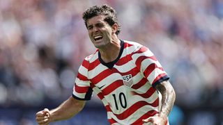 Christian Pulisic celebrates scoring a goal for USA.