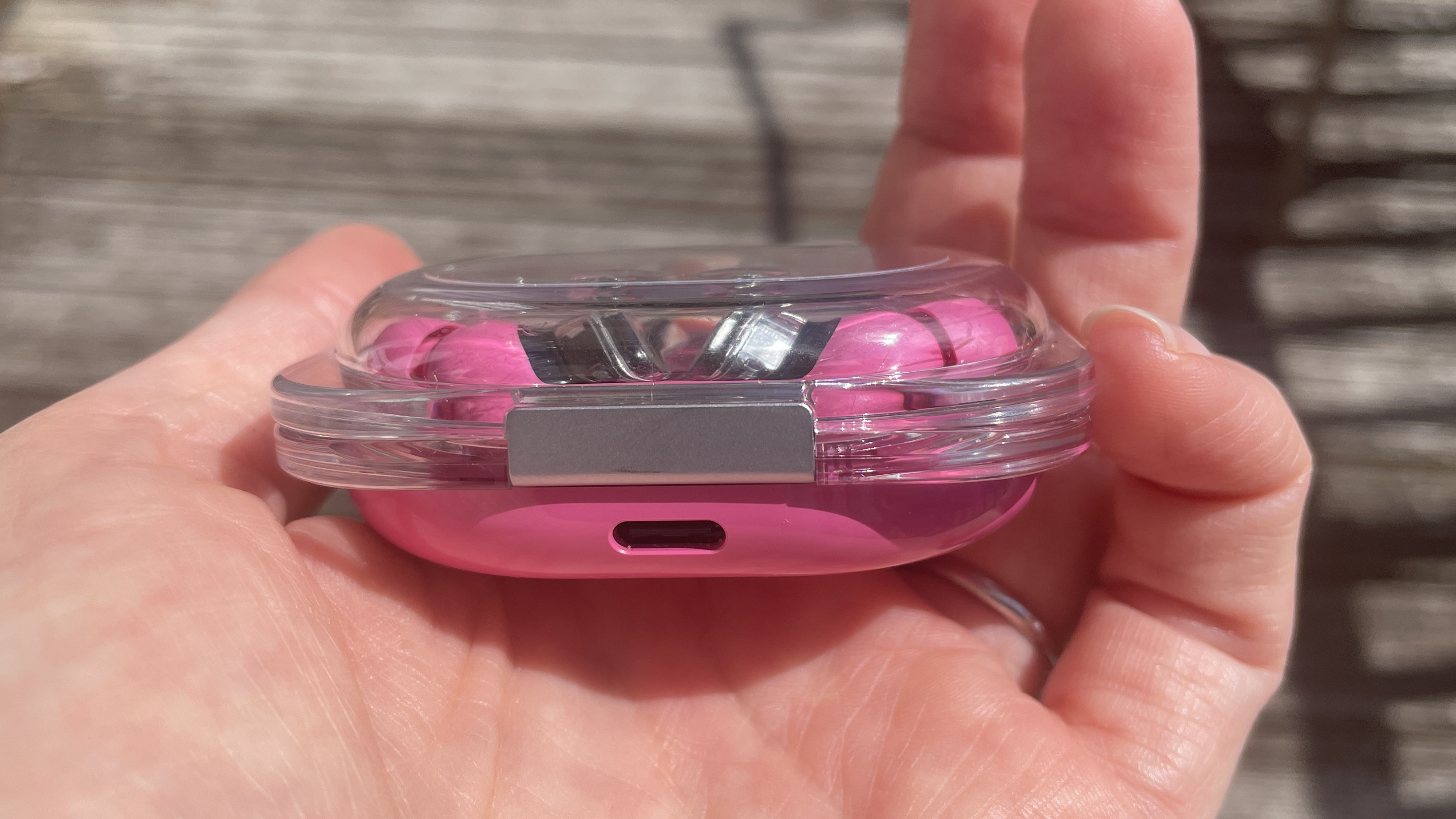 Nothing Ear (3a) in their case, with the USB-C charging port visible