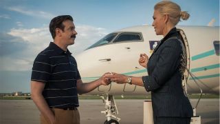 Ted and Rebecca looking at each other near to a private jet in Ted Lasso season 4