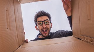 Young man opening delivery box