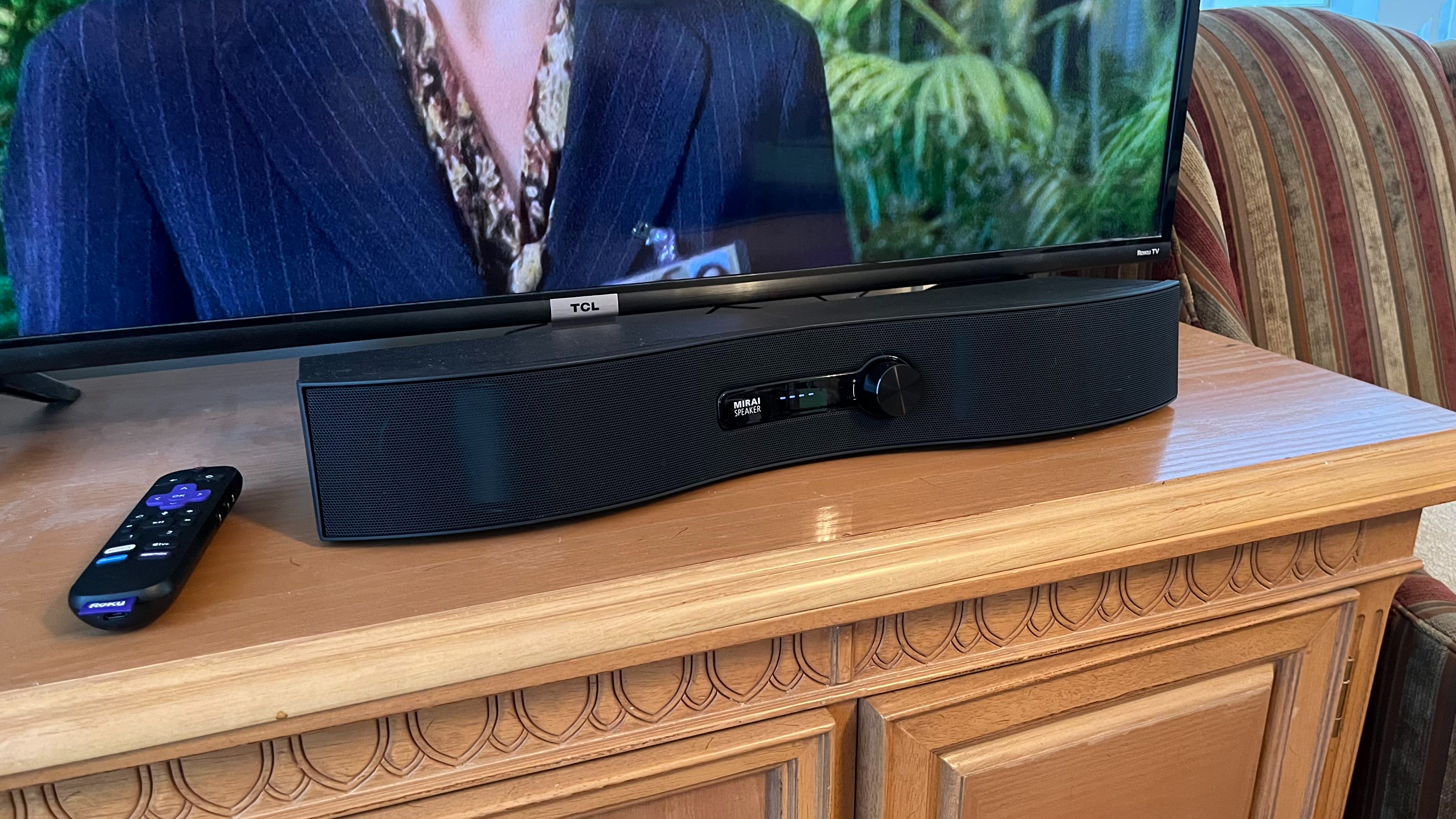 Soundfun Mirai soundbar on table with TV and remote