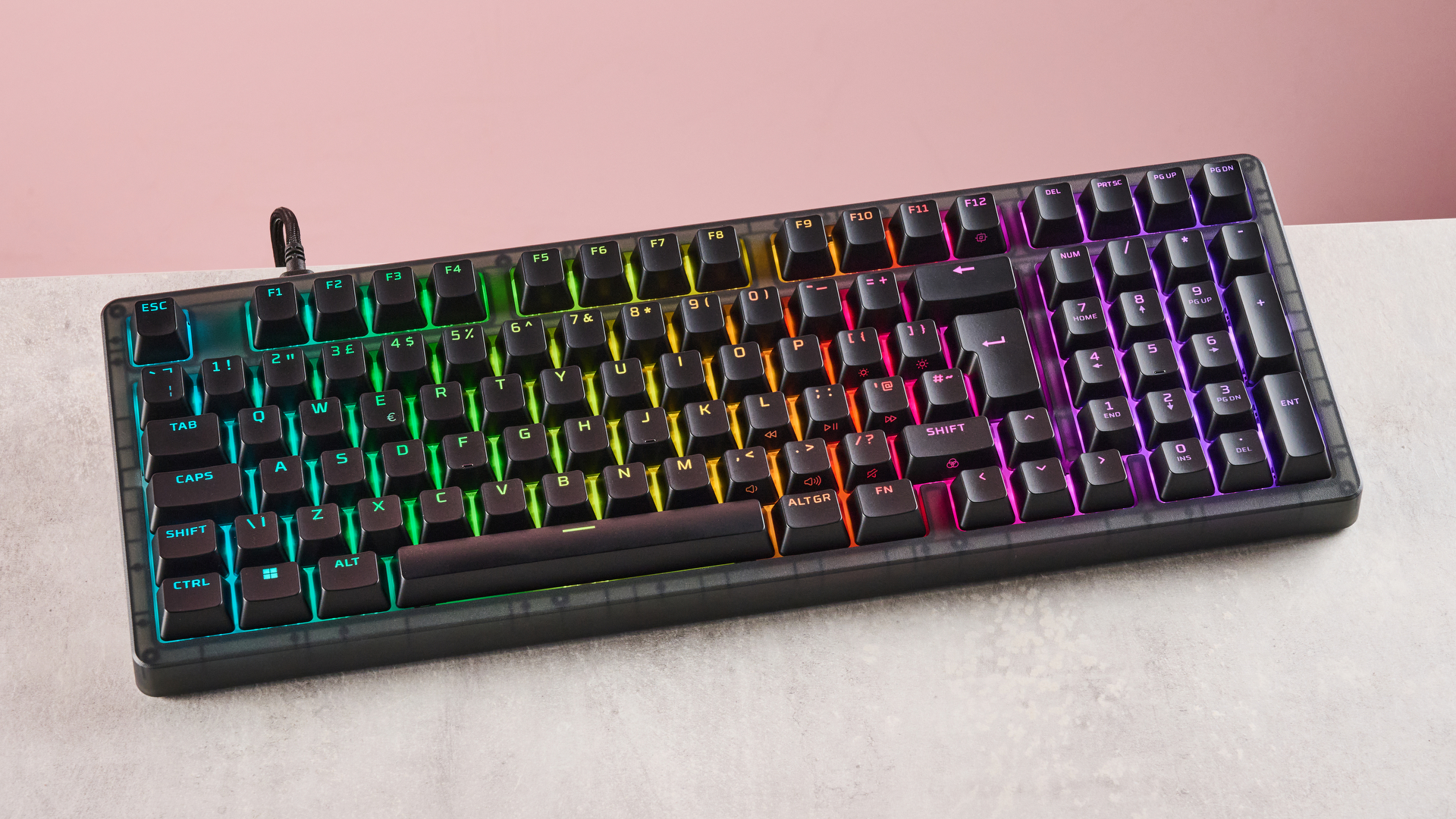 Top-down view of HyperX Origins 2 1800 with RGB backlighting on, on a desk with pink wall in background