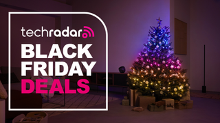 The Philips Hue Festavia string lights are pictured decorating a Christmas tree in a living room. To the right is a large badge which reads "Tech Radar Black Friday Deals".