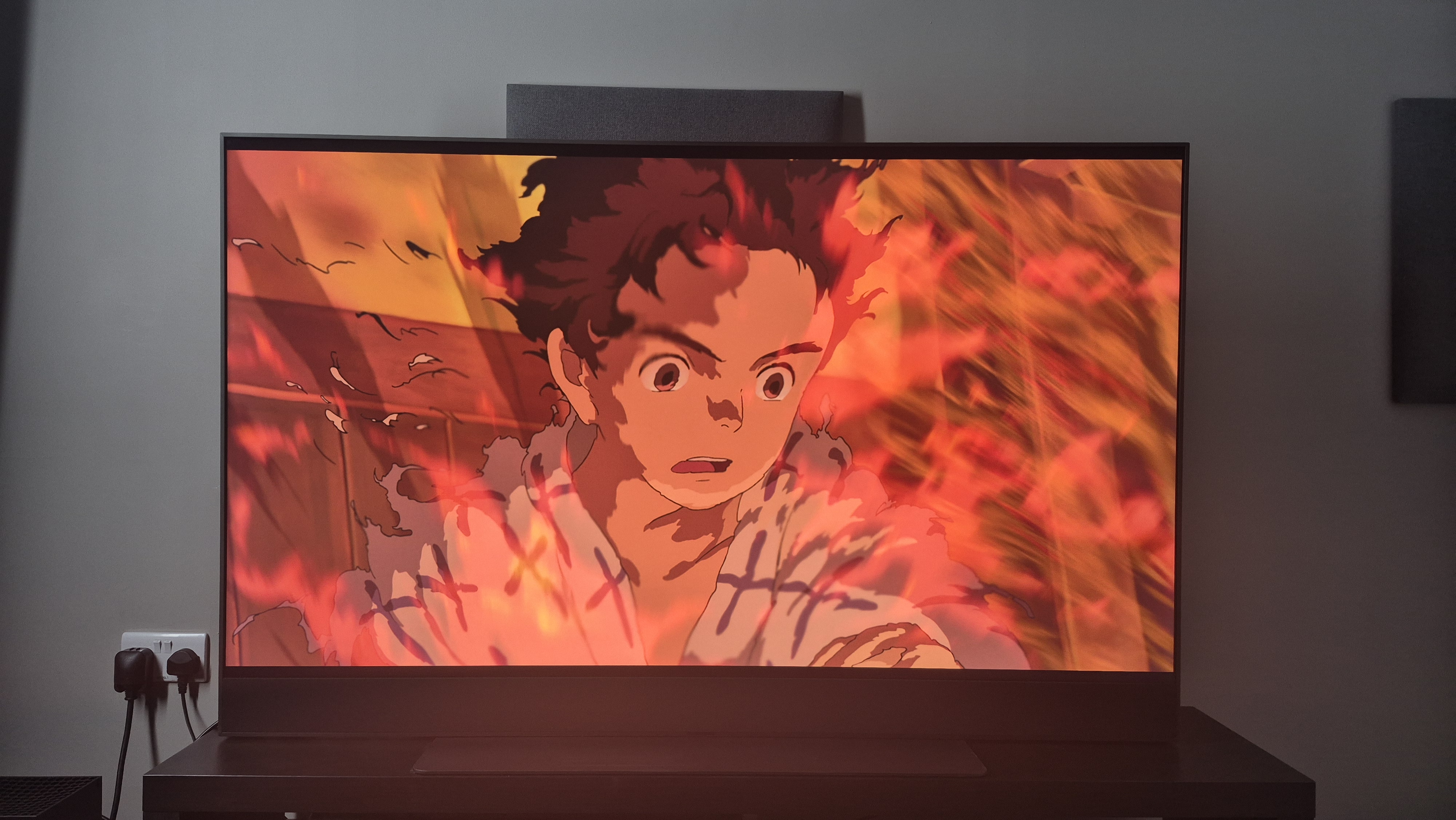 Sky Glass Gen 2 with Mahito from The Boy and the Heron in a flame-lit room