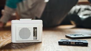 Maxell MXCP-P100S cassette player on a wooden surface. It's a Walkman-esque player with a built-in speaker