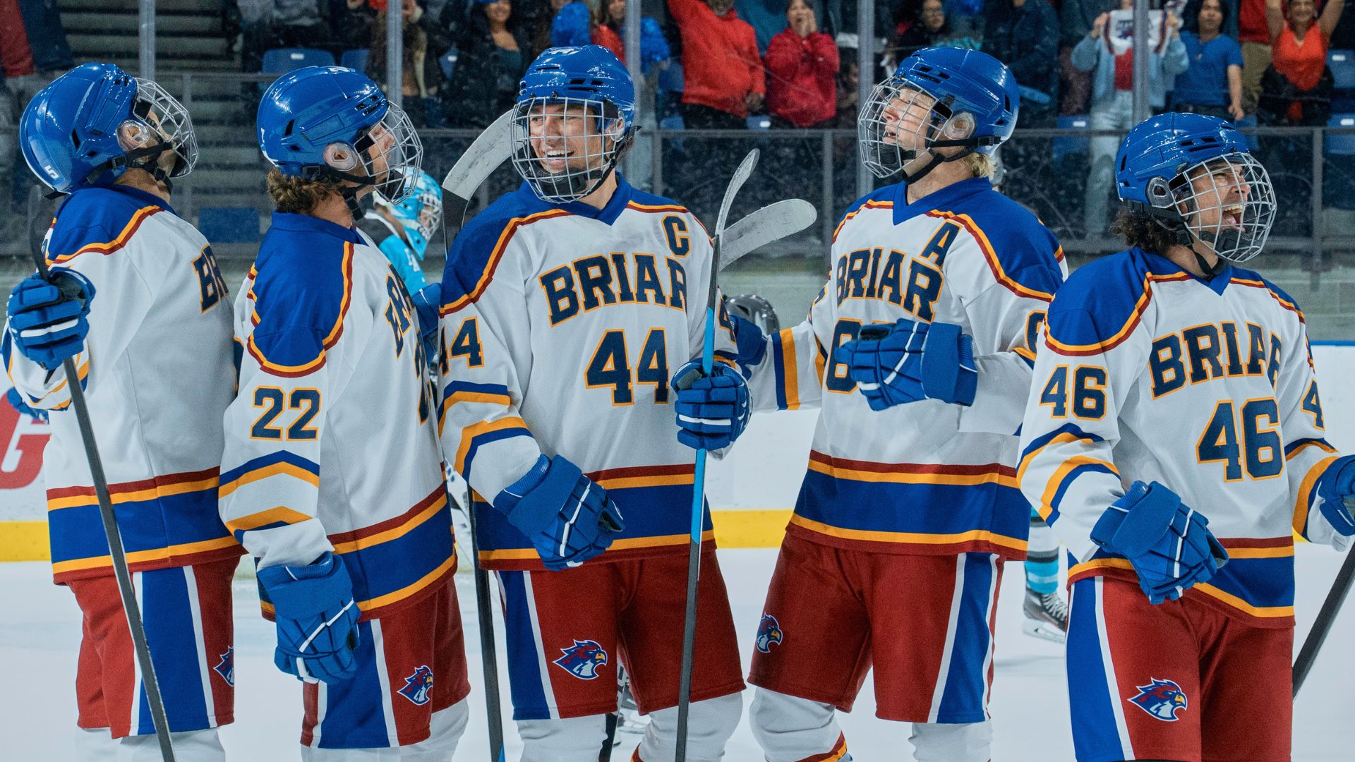 a hockey team celebrates on the ice