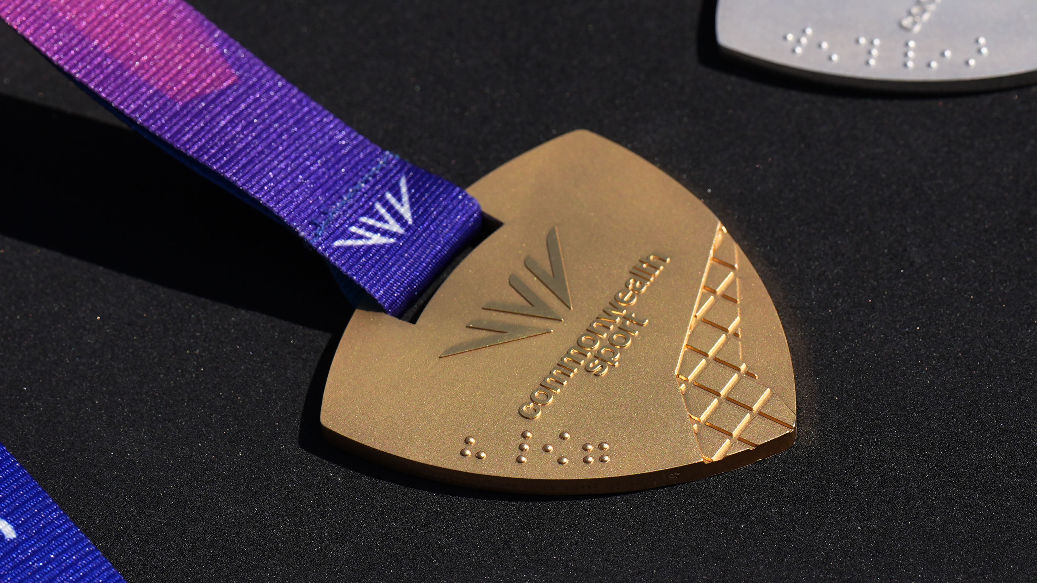 Braille on a Commonwealth Games medal during a visit by Prince William, Prince of Wales to the Ysgol Gymraeg Llundain