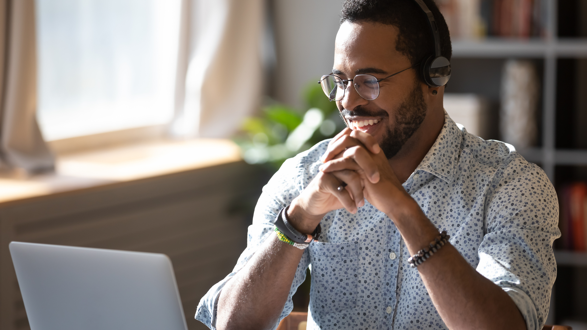 Man using a headset for video and voice calling on a laptop