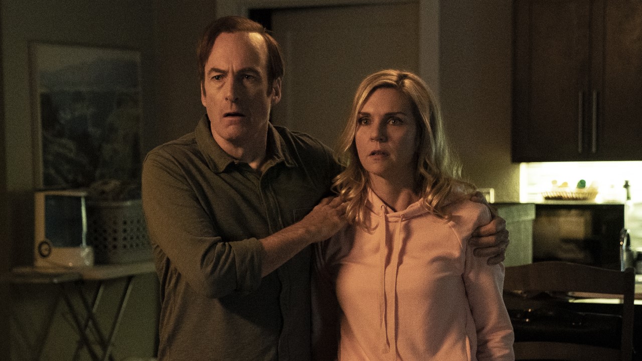 Saul and Kim look shocked as they stand in a dimly lit room in Better Call Saul