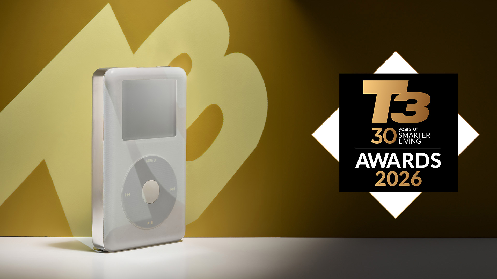 iPod on a white surface in front of a yellow T3 logo, and next to a T3 30th Anniversary Awards 2026 logo