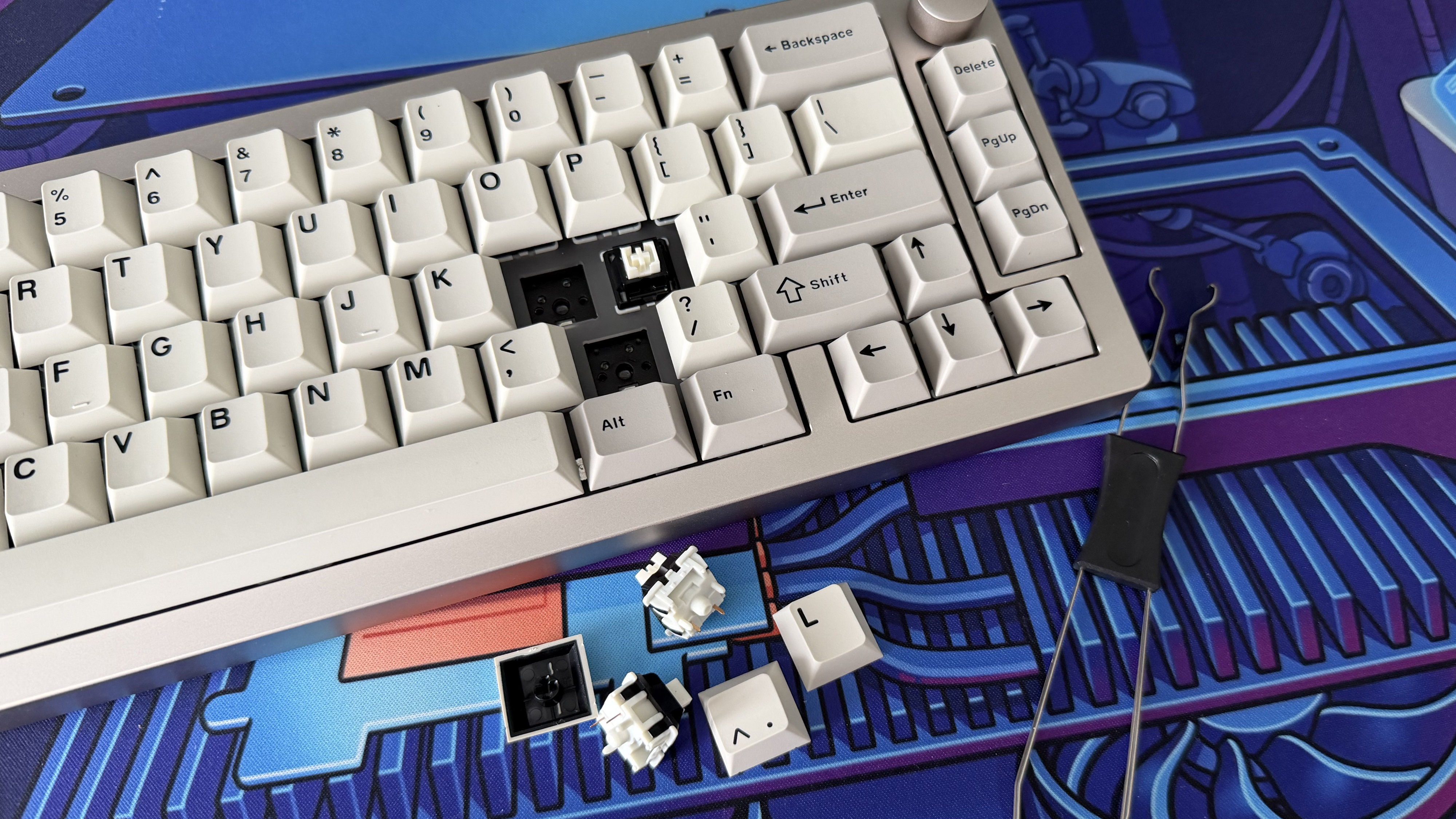 The Epomaker 65 with multiple keycaps and switches removed; the switches and the tool used to remove them sit beside the keyboard.
