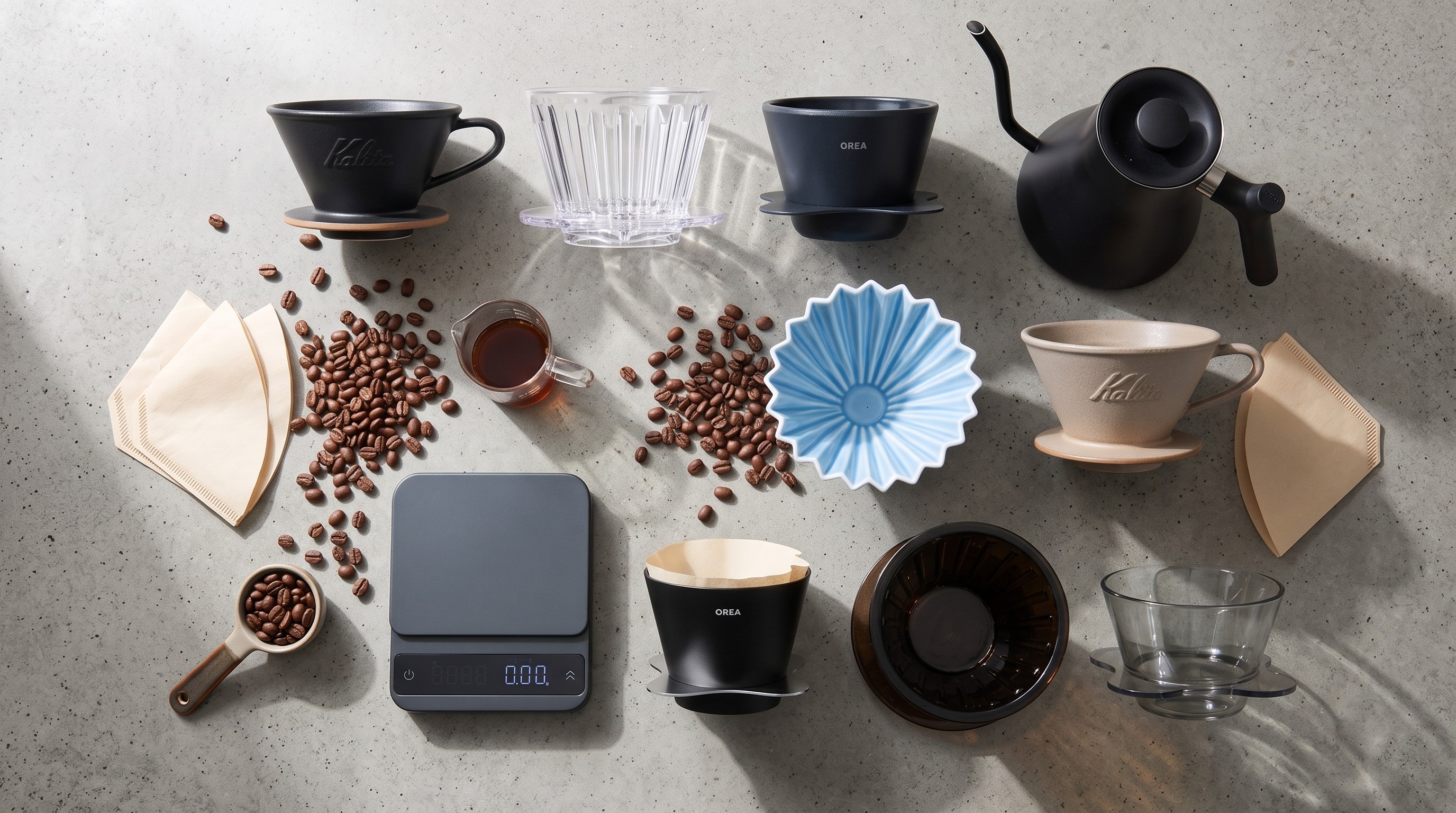 Collection of drip coffee makers on table with beans and filters