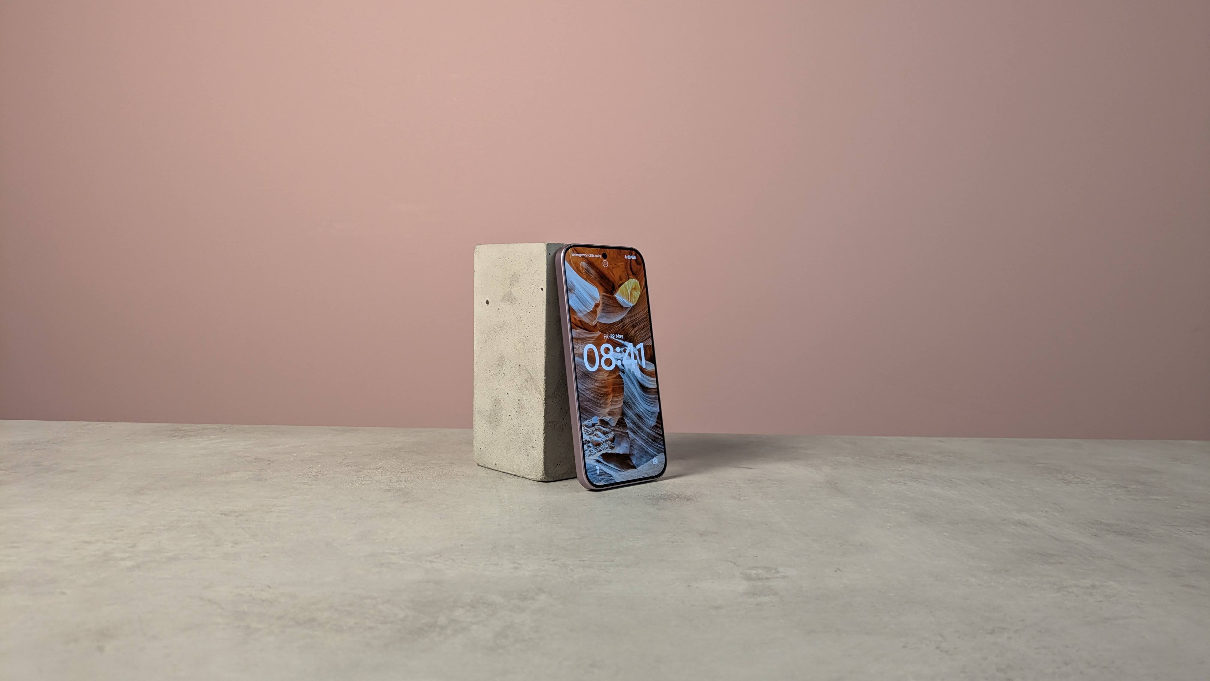 Three-quarter view of Xiaomi 17T on a desk with pink wall in background