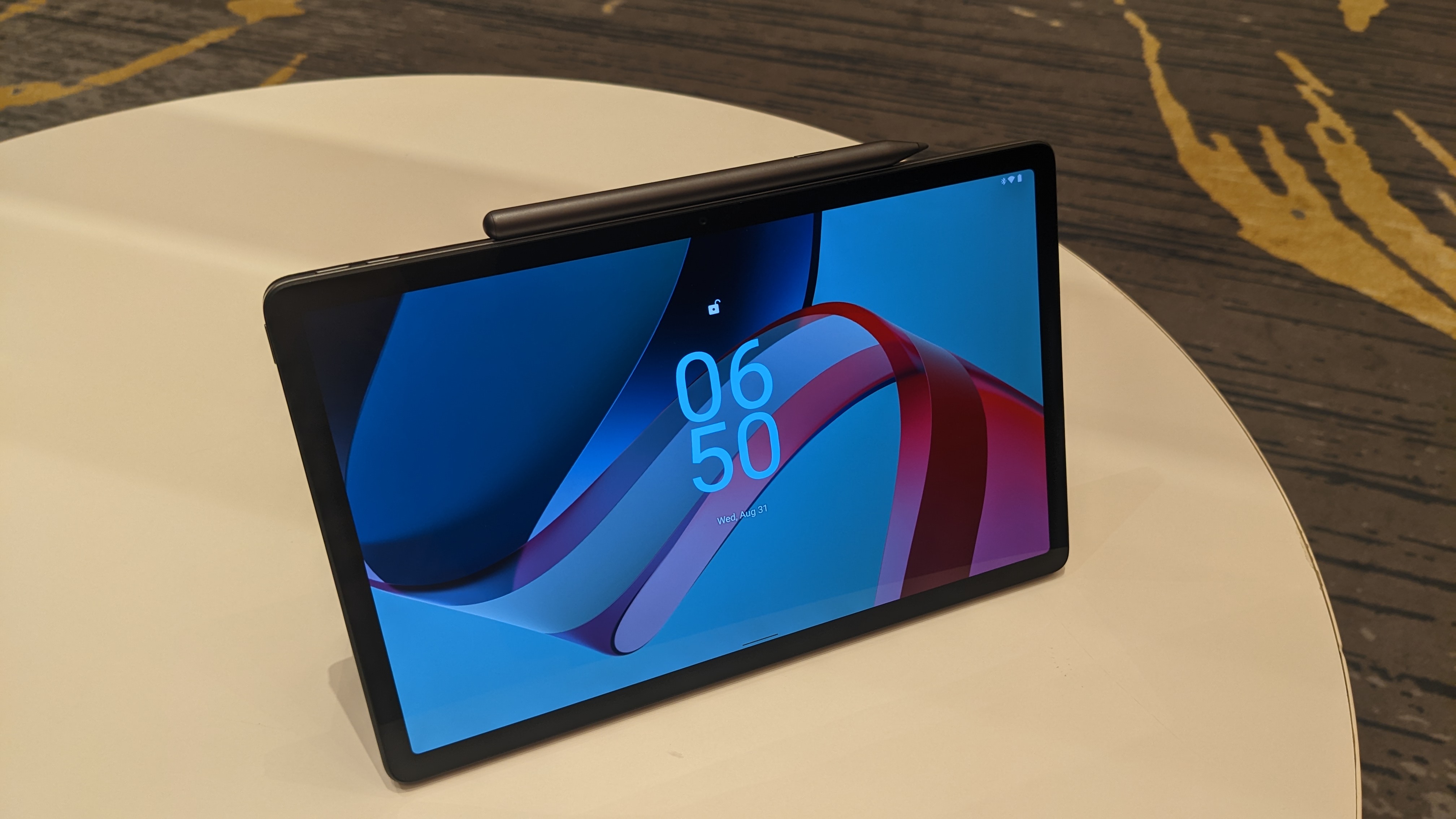 Lenovo Tab P11 Pro Gen 2 on a round wooden table.