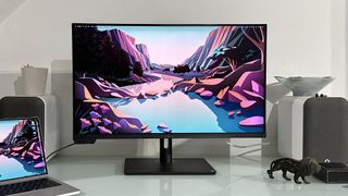 The Asus ProArt PA32KCX 8K monitor on a white desk in a home office during our review process