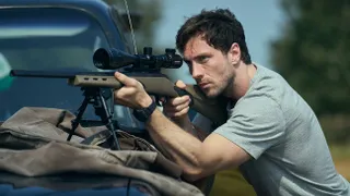 Aaron Taylor-Johnson holding a gun in Fuze