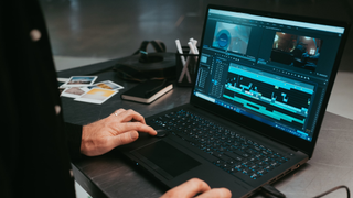 Man using video editor on laptop