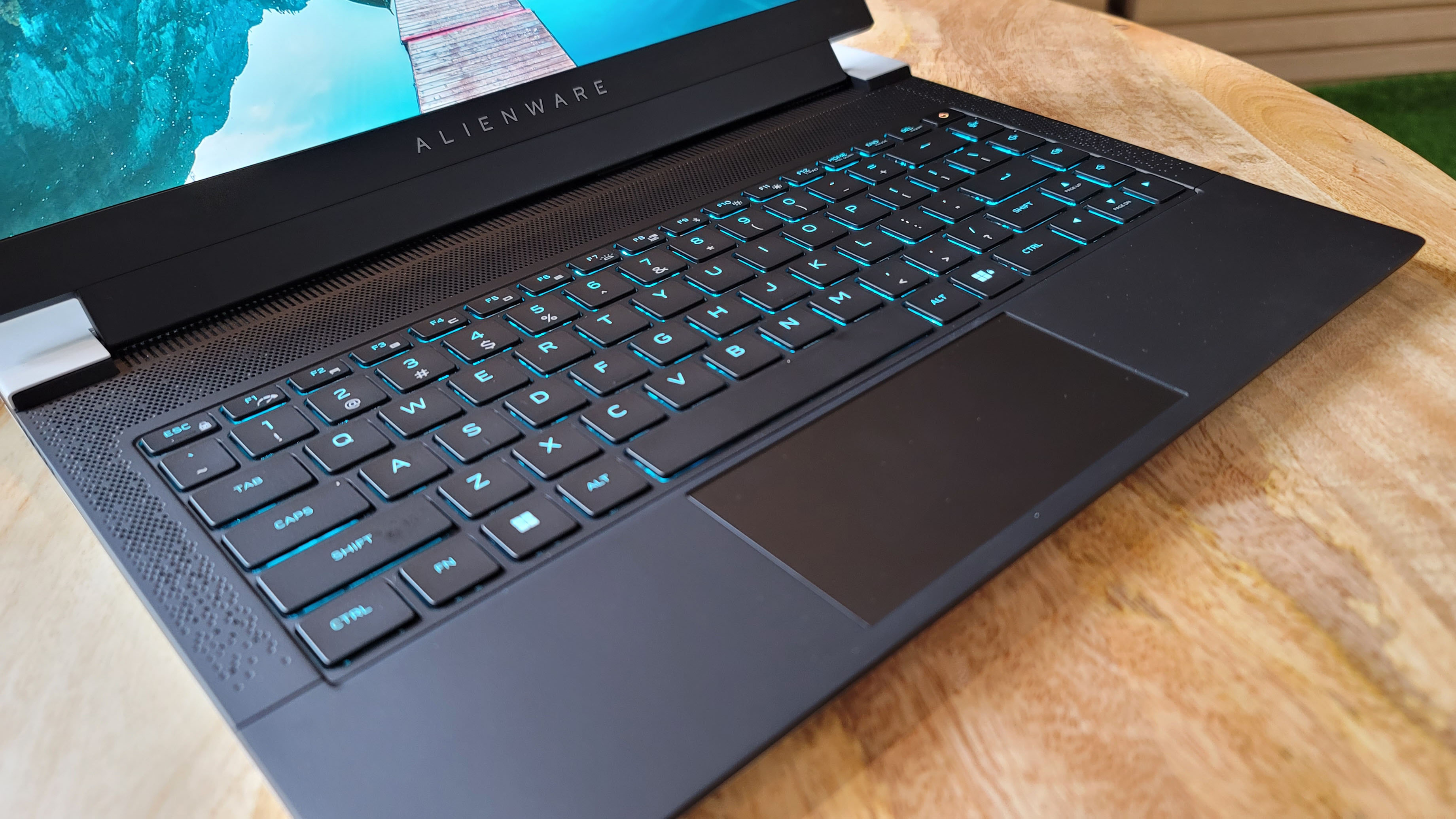 Alienware X14 on a table next to a cactus or something