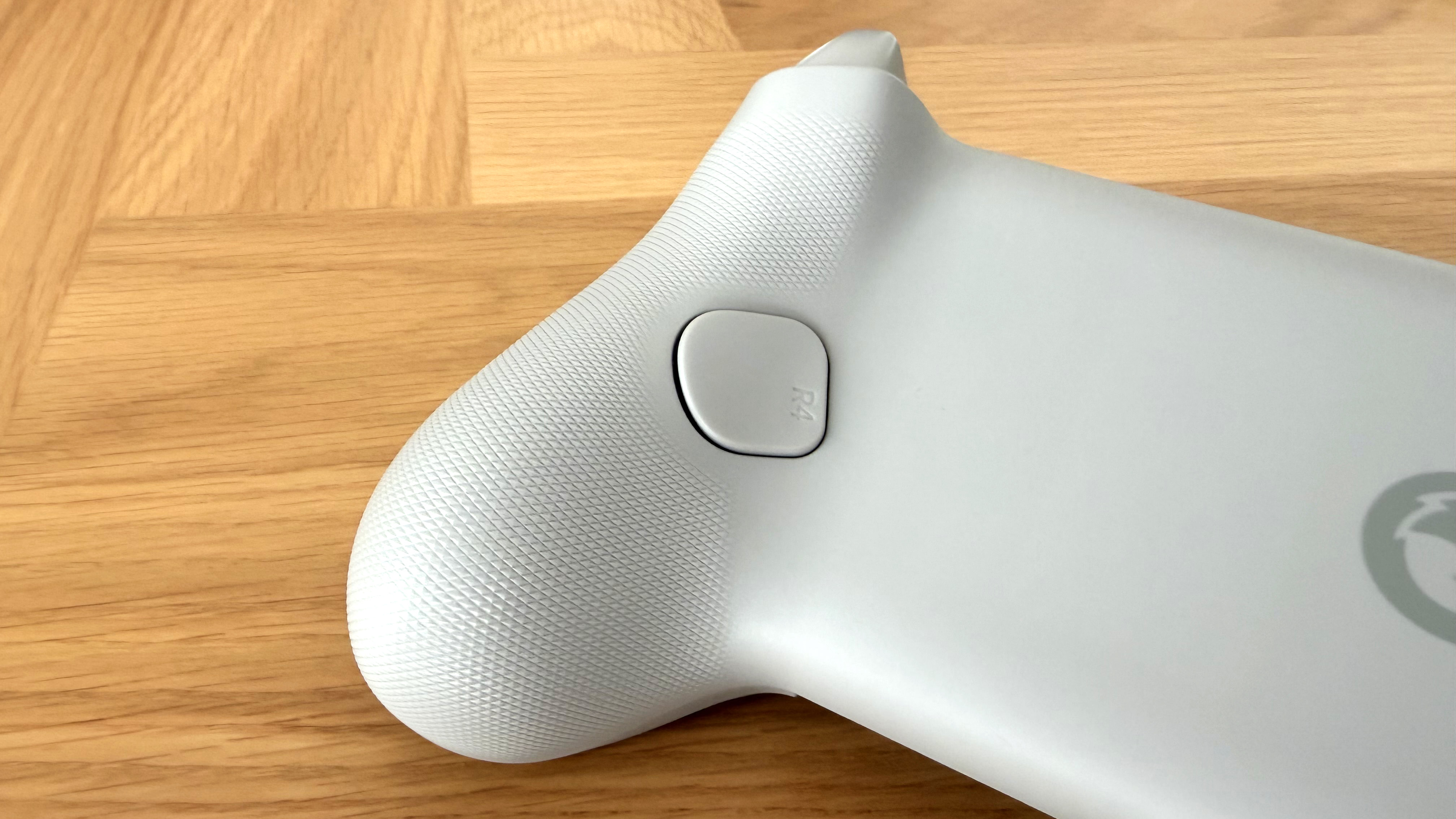 The GameSir G8 Galileo mobile gaming controller on a wooden surface.