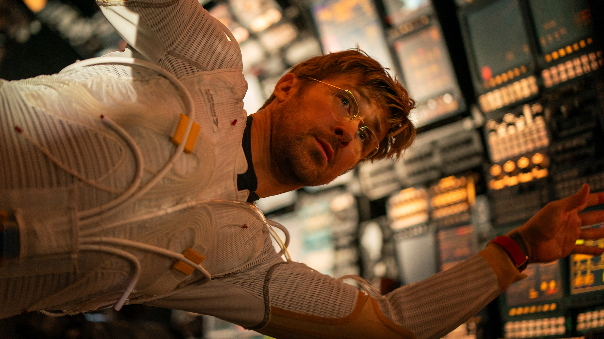 Ryland Grace wearing part of a space suit and floating in zero gravity inside his spaceship in Project Hail Mary