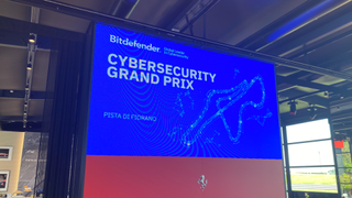 A photo of a screen displaying the Bitdefender Cybersecurity Grand Prix at Pista Di Fiorano in Italy