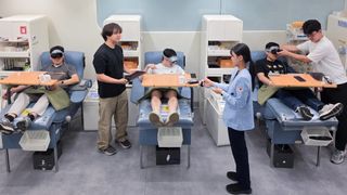 People giving blood while wearing a Samsung Galaxy XR headset