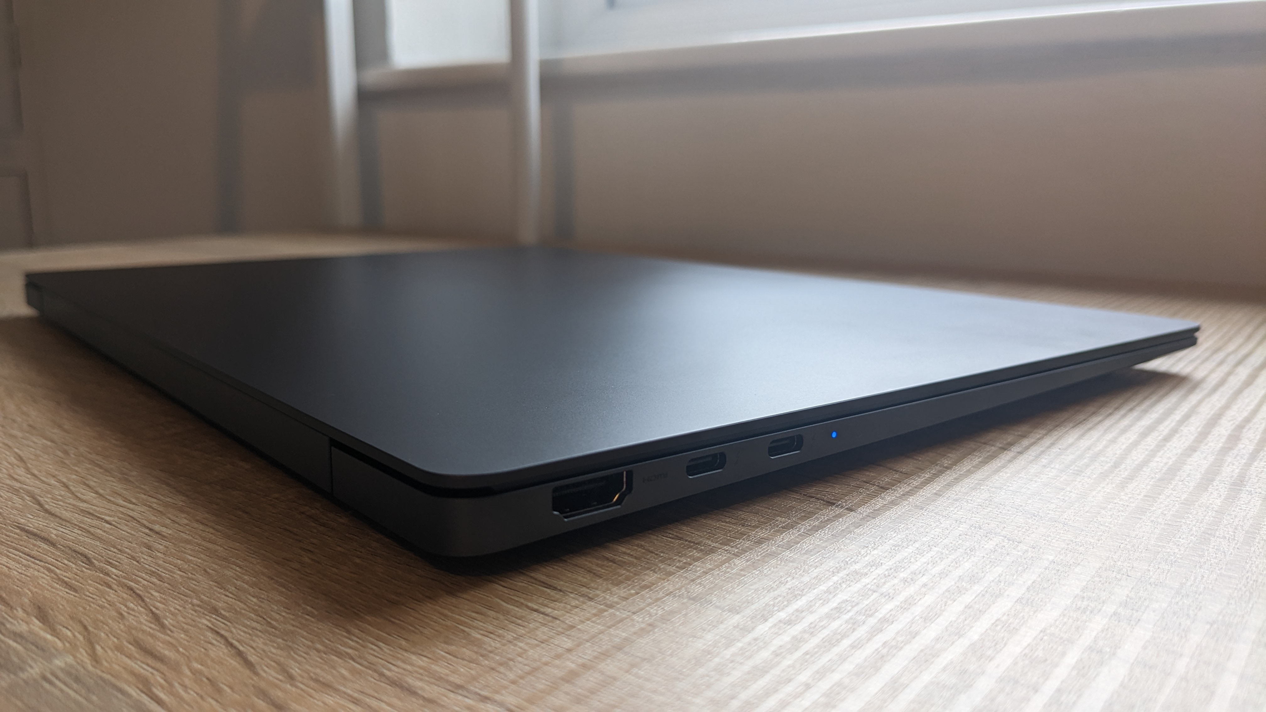 The Samsung Galaxy Book3 Pro 14-inch laptop pictured atop a wooden desk.