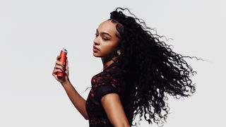Woman holding red Dyson HushJet Mini Cool Fan
