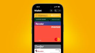 The Apple Wallet interface on an orange background